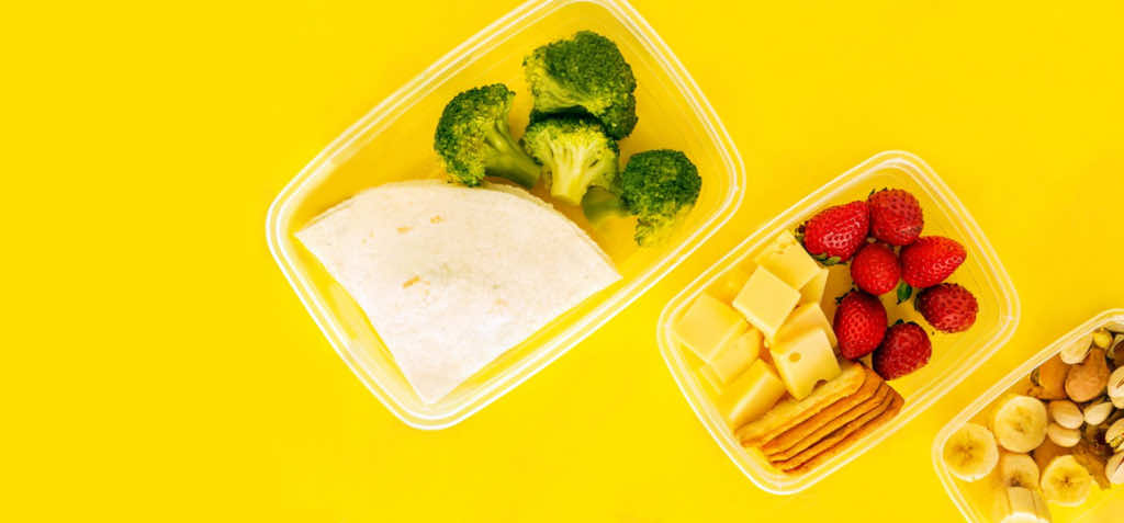 stock-photo-food-in-plastic-containers-ready-to-eat-from-above-to-take-away-on-yellow-background-healthy-food-1655778574.jpg